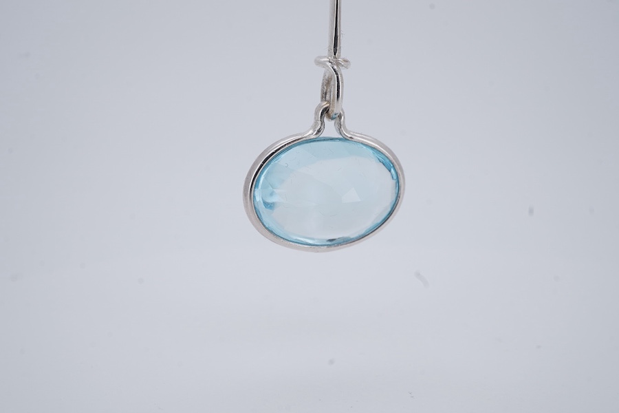 Georg Jensen, a blue topaz necklace, centring on a hook clasp suspending an oval blue topaz pendant, pendant length 5.5cm, necklace length 43cm, stamped GJ for Georg Jensen, 925S and European convention assay marks for s